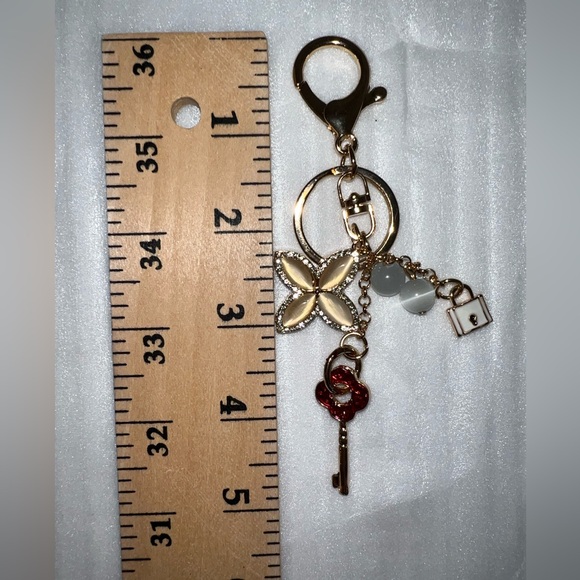 Gold-tone keychain bag charm floral design and lock and key accents - Picture 4 of 5